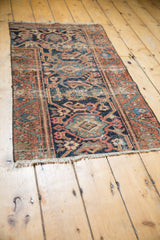 Hand knotted Persian Mahal rug border corner featuring rust, navy turtle, vine motifs.