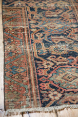 Mahal rug border corner with rust and navy turtle vine motifs, showing even wear.