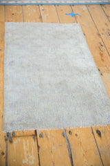 Vintage distressed Oushak rug mat with low pile texture and subtle silver-grey tones.