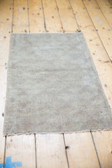 Distressed low pile and secured fringe of the vintage Oushak mat.