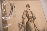 Close-up of an antique fashion print showing a colored front view and a monochrome back sketch.