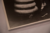 Bottom corner detail of the black and white Alice in Wonderland photograph showing a small brush.