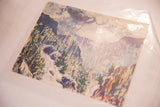 Textured vintage landscape print showcasing dramatic green foliage and misty blue mountains.