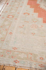 Soft plush pile of a distressed vintage Oushak carpet with fringed edge.