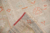 Hand-knotted vintage distressed Oushak pile, peach motifs, natural fringe, and secure red edge.