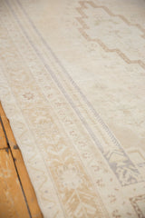 Distressed vintage Oushak rug pile with even wear, revealing faint foundation and subtle beige patterns.
