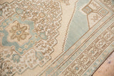 Vintage Oushak rug corner showing geometric floral spandrel and border in pale ocean blue and ivory.