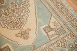 Corner detail of distressed Oushak rug with geometric spandrel, pale ocean blue and ivory.