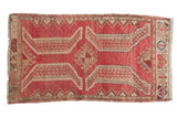 Distressed Oushak rug with raspberry red, beige stylized leaves, and a central medallion.
