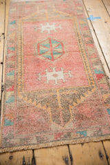 Distressed vintage Oushak rug in blush, with a hexagonal geometric cross hatch medallion.