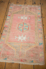 Distressed Oushak runner end, hexagonal medallion, blush, pale charcoal, faded tangerine, and fringe.