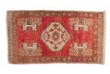 Distressed Oushak rug, rich blush and ivory, oversized medallion, stylized motifs.