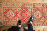 Distressed Oushak runner's triple medallion, hook and latch motif, cherry red, aqua.