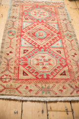 Distressed Oushak rug's cherry red, aqua, and beige pomegranate main border detail.