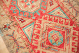 Hand-knotted Oushak runner detail: distressed texture, cherry red, aqua, beige hook motifs.