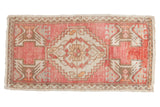Blush and ivory distressed Oushak rug mat, featuring a serrated medallion and geometric plant motifs, 1'8