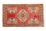 Distressed vintage Oushak hand knotted rug with central medallion, germinating plants in cochineal red and beige.