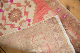 Vintage distressed Oushak rug mat revealing worn pile, foundation, and white fringe.