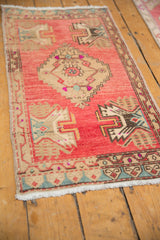 Distressed vintage Oushak runner showing white fringe, side cord selvage, and geometric pattern.