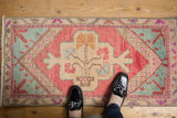 Distressed Oushak rug corner, blush, pale raspberry, mint germinating tree motif.