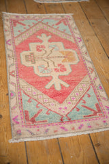 Distressed Oushak rug corner, blush, mint green border, ivory field, germinating tree detail.