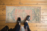 Hand-knotted distressed Oushak rug mat, geometric medallion in dusty rose and teal.