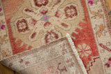 Distressed Oushak rug pile with even wear, showing original selvage and reverse side.