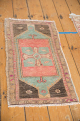 Distressed Oushak rug's right side, featuring geometric border, faded colors, and fringe.