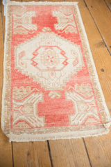 Distressed Oushak rug texture with soft blush pink and ivory, featuring even wear.