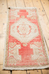 Distressed Oushak rug corner, worn pale blush pink field with ivory details, intact selvage and fringe.
