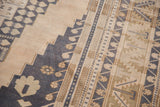 Distressed Oushak rug texture with dusty navy blue and antique ivory stepped geometric borders.