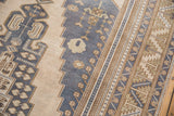 Stepped dusty navy blue spandrel detail and wide Oushak border with serrated leaves, blossoms.
