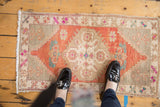 Vintage Distressed Oushak rug mat, brick red floral medallion, beige border, shown in context for scale.