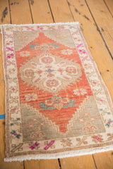 Vintage Oushak rug's distressed pile, showing abrashed silver grey field and colorful floral border.