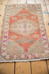 Intact side selvage and patterned border of distressed Oushak rug with brick red and turquoise.