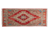 Distressed Oushak rug runner, stepped medallion, germinating plant motifs in cherry red, ivory, and blue.