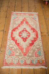 Decorative corner of distressed Oushak runner featuring cherry red, sky blue, and ivory patterns.