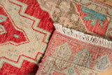 Distressed Oushak rug pile in cherry red, ivory, light blue stepped pattern, with muted reverse.