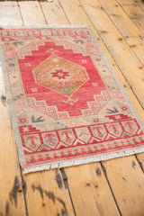 Cherry red, gold, and ivory distressed Oushak rug border with geometric motifs and fringe.