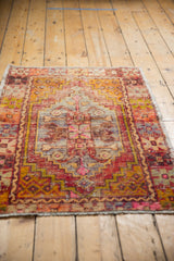 Detailed low pile of a vintage distressed Oushak rug, showing faded aubergine, saffron, and stepped patterns.
