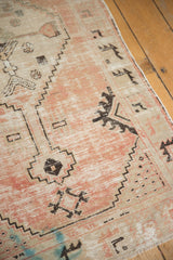 Textural distressed Oushak rug runner with pale blush, ivory, black patterns, subtle blue bleed.