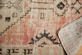Distressed Oushak rug: blush rose, ivory pile, geometric forms, and reverse showing blue marks.