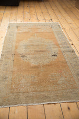Distressed vintage Oushak rug, showcasing faded medallion, soft terracotta, and charcoal abrashes.