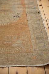 Distressed Oushak rug pile with mostly even wear, faint foundation visible, terra cotta, platinum.