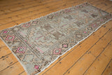 Runner end of vintage distressed Oushak, geometric floral bouquets, dusty rose and brown.