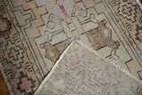Vintage Oushak rug reverse revealing hand-knotted foundation, even wear, and pink processing mark.