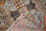 Hand-knotted foundation and distressed Oushak pile with tangerine orange and bright pink.