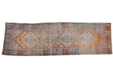 Vintage distressed Oushak runner with tangerine, blue, aubergine floral medallion, 3'3