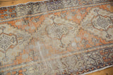 Distressed Oushak rug with faded tangerine orange pile and visible foundation.