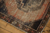 Distressed Oushak runner corner detail with worn pile, visible foundation, and dark patterned border.